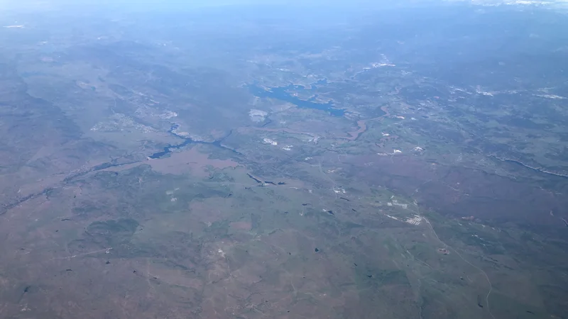 2022-03-24 20 09 42 UTC minus 7 View north from an airplane across western Tuolumne County and southern Calaveras County, California, with Lake Tulloch in the upper left and New Melones Lake in the upper center.jpg