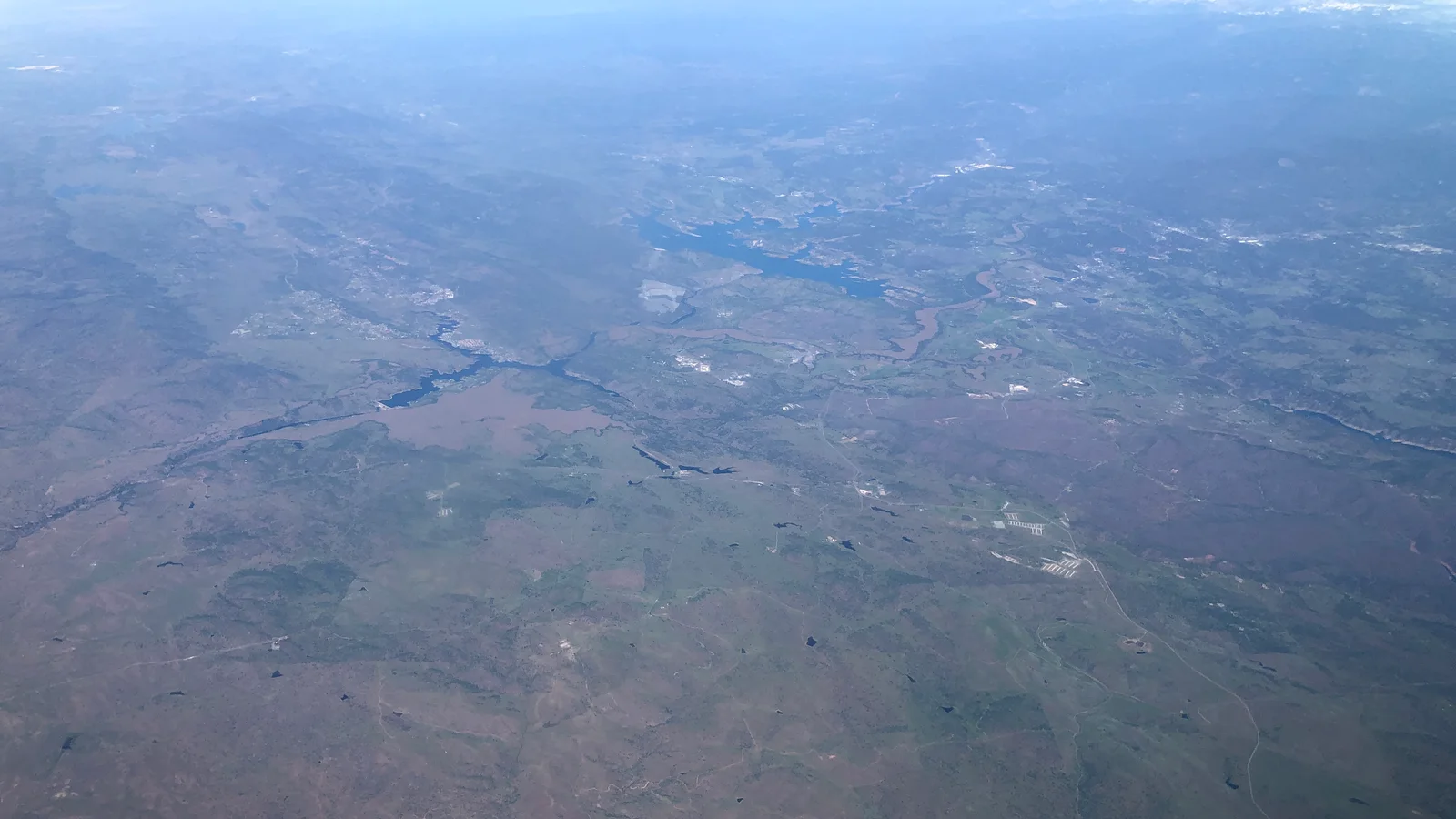 2022-03-24 20 09 42 UTC minus 7 View north from an airplane across western Tuolumne County and southern Calaveras County, California, with Lake Tulloch in the upper left and New Melones Lake in the upper center.jpg